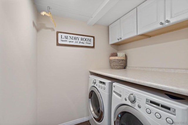 washroom with cabinets and washer and clothes dryer