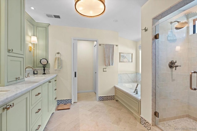 bathroom with vanity and separate shower and tub