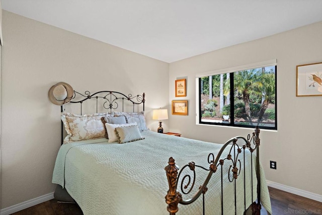 bedroom with dark hardwood / wood-style flooring