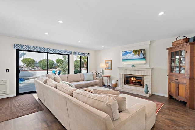 living room featuring a fireplace and dark hardwood / wood-style floors