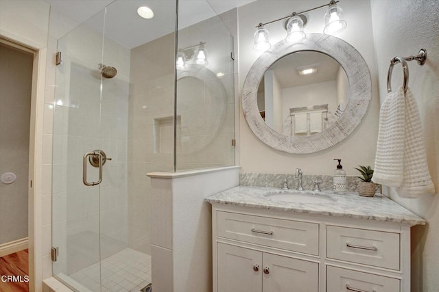 bathroom with vanity, hardwood / wood-style floors, and an enclosed shower