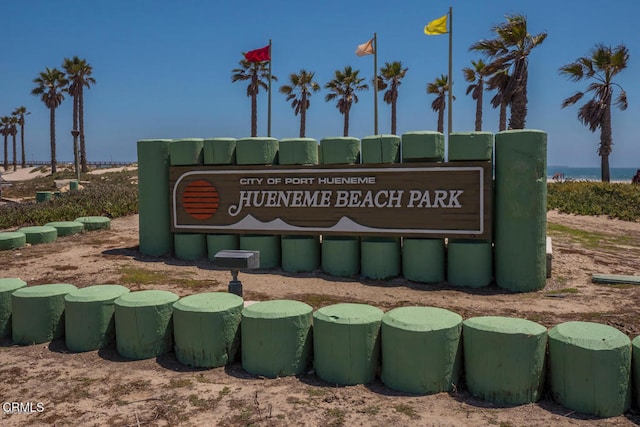 community sign featuring a water view