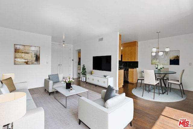 living room featuring a chandelier and light wood-type flooring