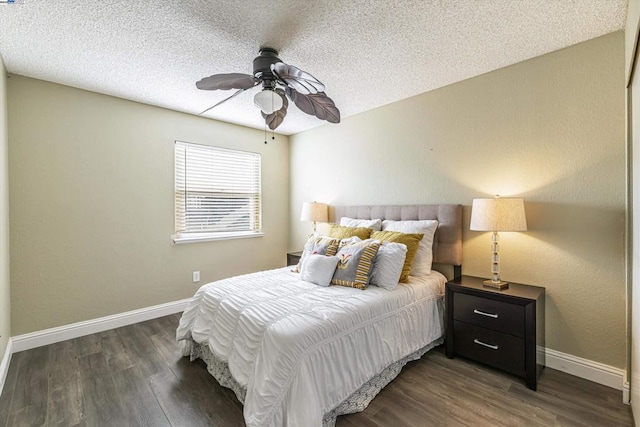 bedroom featuring ceiling fan, dark wood-type flooring, and a textured ceiling