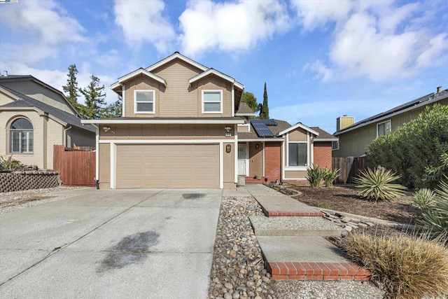 front of property featuring a garage and solar panels