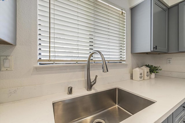 details with gray cabinets and sink