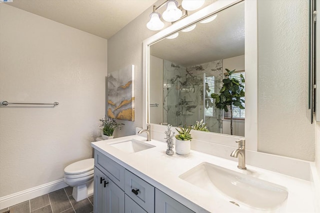 bathroom featuring vanity, toilet, and a shower with shower door