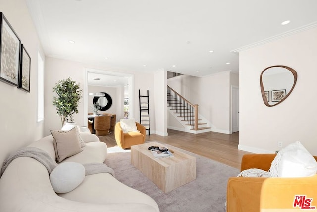 living room featuring ornamental molding and light wood-type flooring