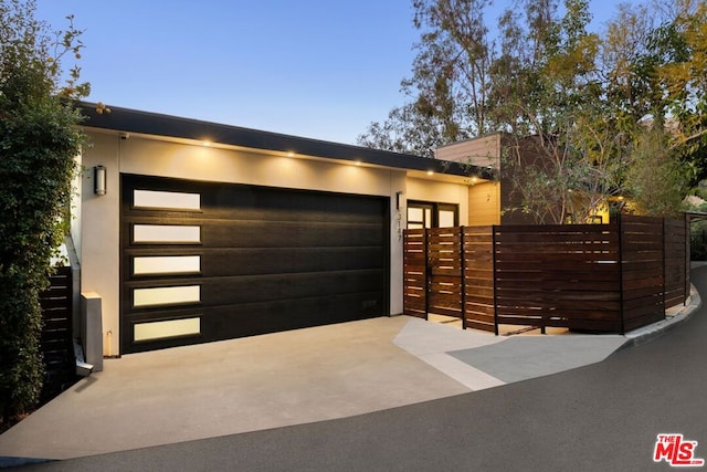 view of garage at dusk