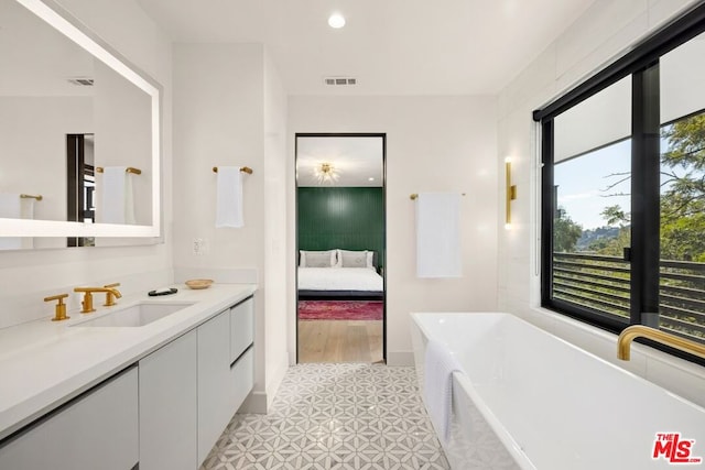 bathroom with a bathing tub and vanity