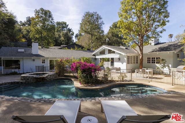 view of swimming pool featuring an in ground hot tub and a patio