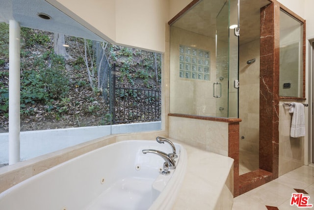 bathroom featuring plus walk in shower and tile patterned floors