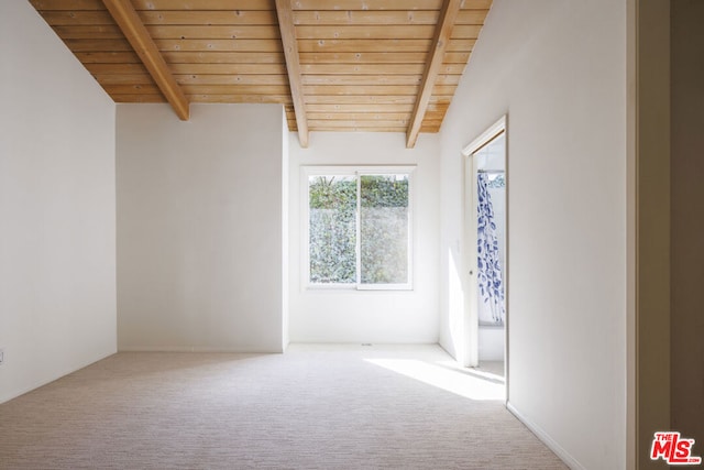 unfurnished room featuring wood ceiling, lofted ceiling with beams, and carpet