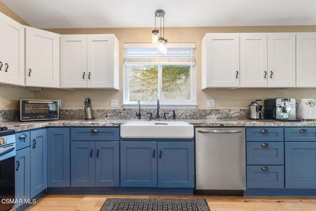 kitchen featuring white cabinetry, sink, blue cabinets, and appliances with stainless steel finishes