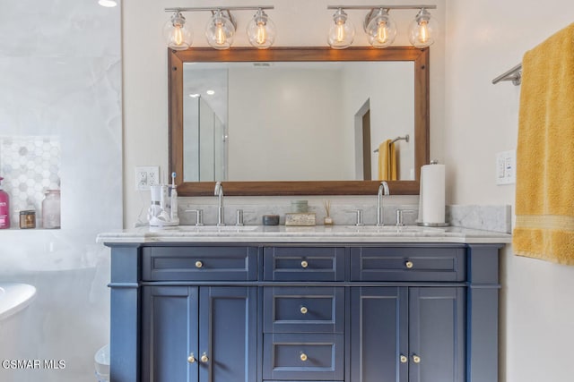 bathroom featuring a tub to relax in and vanity