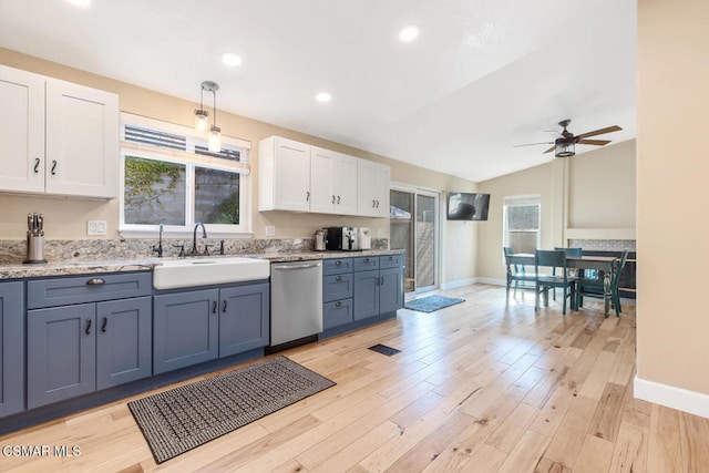 kitchen with sink, light hardwood / wood-style flooring, white cabinetry, decorative light fixtures, and stainless steel dishwasher