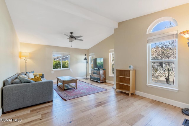 living room with vaulted ceiling with beams, ceiling fan, and light hardwood / wood-style flooring