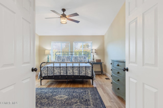 bedroom featuring hardwood / wood-style flooring, ceiling fan, and lofted ceiling