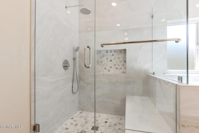 bathroom featuring a shower with shower door