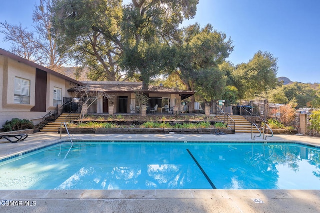 view of swimming pool with a mountain view