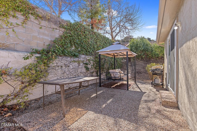 view of patio with a grill and a gazebo