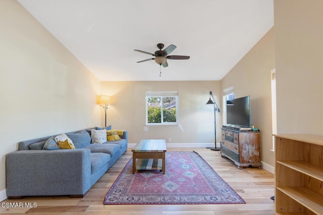 living room with ceiling fan and light hardwood / wood-style flooring