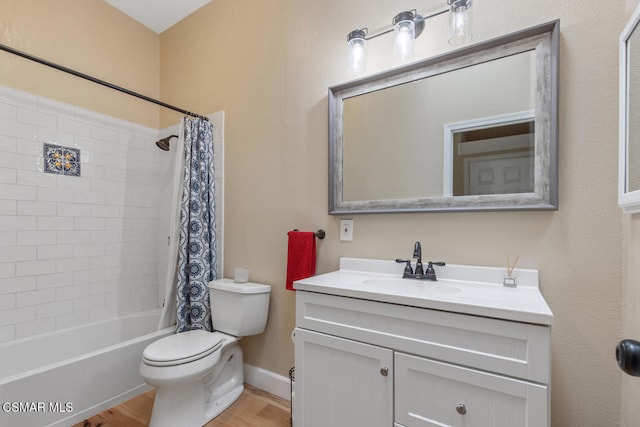 full bathroom featuring vanity, hardwood / wood-style flooring, toilet, and shower / bath combo