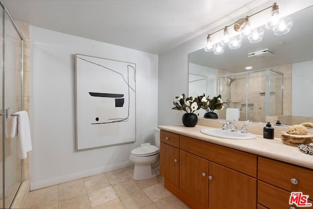 bathroom featuring vanity, a shower with shower door, tile patterned floors, and toilet