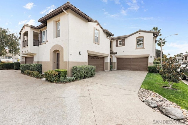 mediterranean / spanish house with a garage