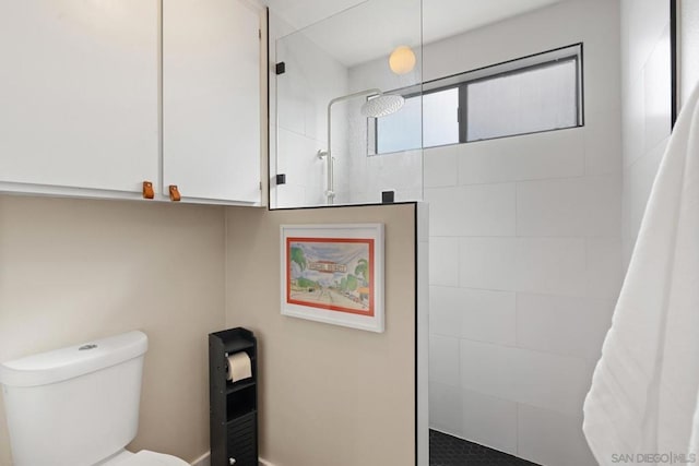 bathroom featuring walk in shower and toilet