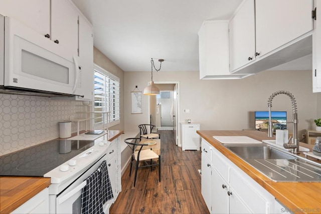 kitchen with sink, white cabinetry, decorative light fixtures, dark hardwood / wood-style floors, and white appliances