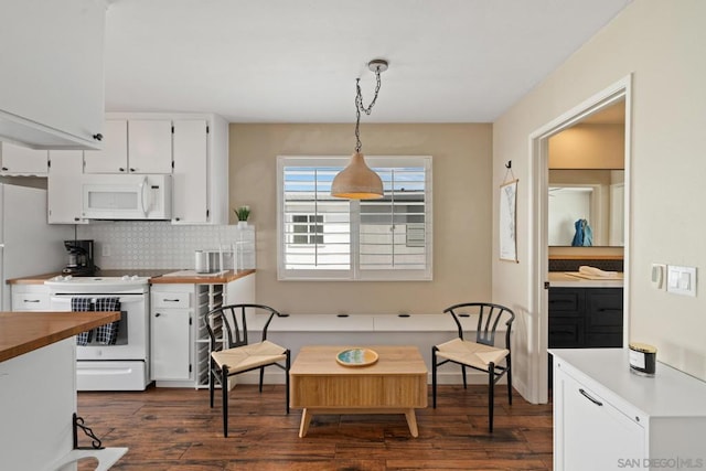 kitchen with white cabinets, dark hardwood / wood-style flooring, decorative backsplash, hanging light fixtures, and white appliances