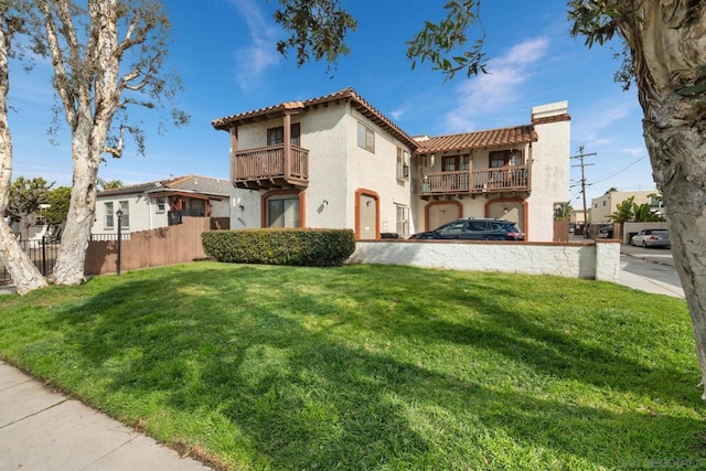 exterior space featuring a front yard and a balcony