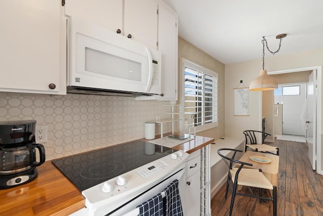 kitchen with white cabinetry, electric range oven, pendant lighting, and dark hardwood / wood-style floors