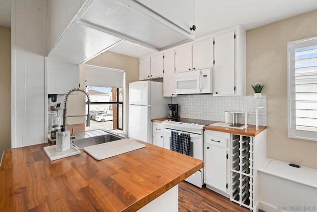 kitchen with sink, white appliances, a wealth of natural light, white cabinets, and decorative backsplash