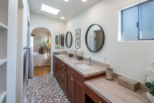 bathroom featuring vanity and a skylight