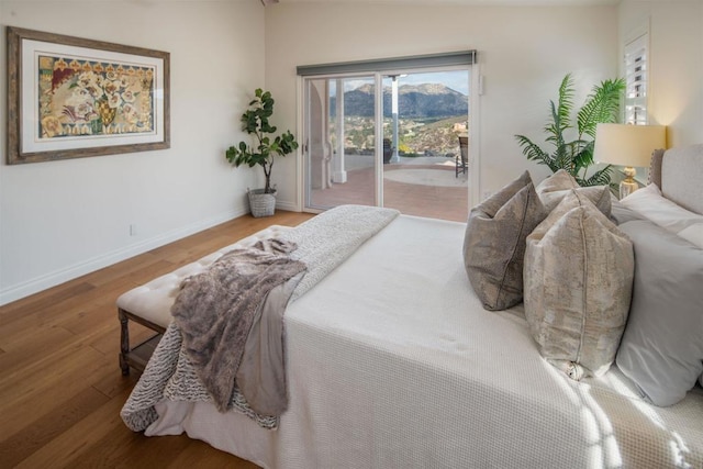 bedroom featuring hardwood / wood-style flooring and access to outside