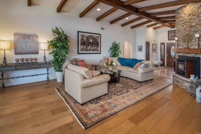 living room with hardwood / wood-style floors, high vaulted ceiling, and beamed ceiling