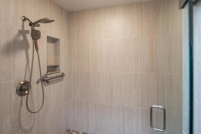 bathroom featuring a shower with shower door