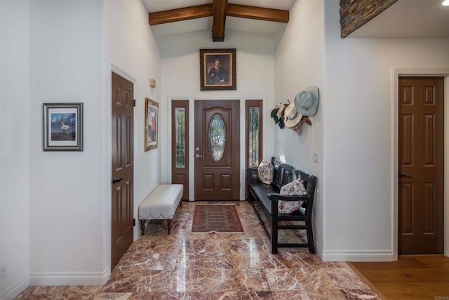 entryway featuring lofted ceiling with beams