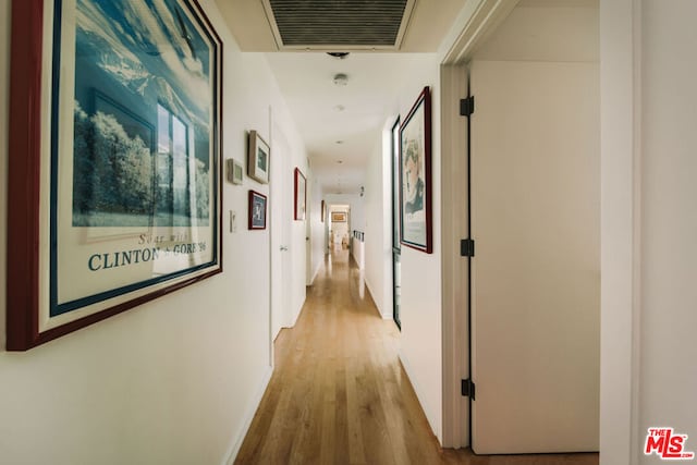 hallway with light wood-type flooring