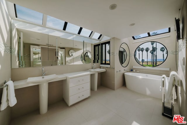 bathroom featuring a washtub, sink, and tile patterned floors