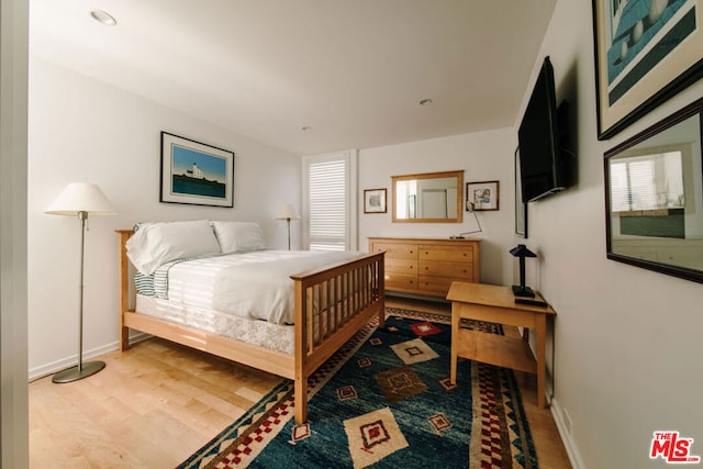 bedroom with wood-type flooring