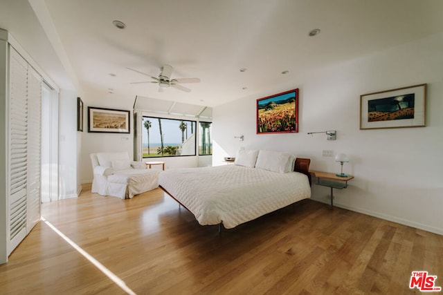 bedroom with wood-type flooring and ceiling fan