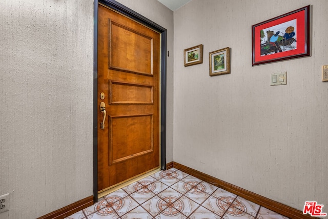 doorway featuring light tile patterned flooring