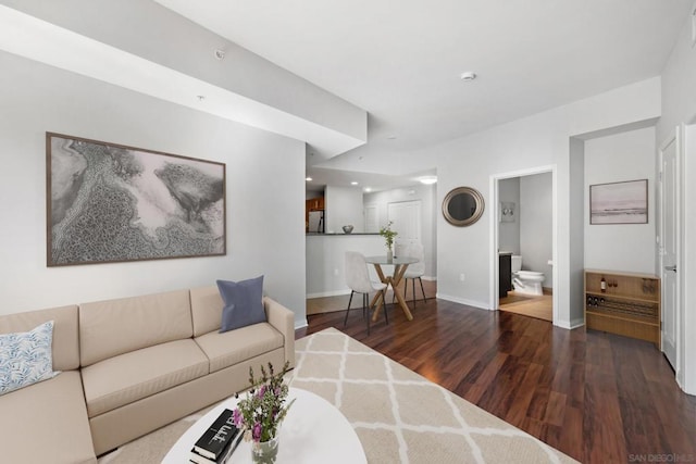 living room with dark hardwood / wood-style flooring