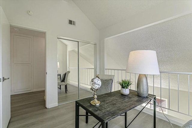 office featuring hardwood / wood-style floors and vaulted ceiling