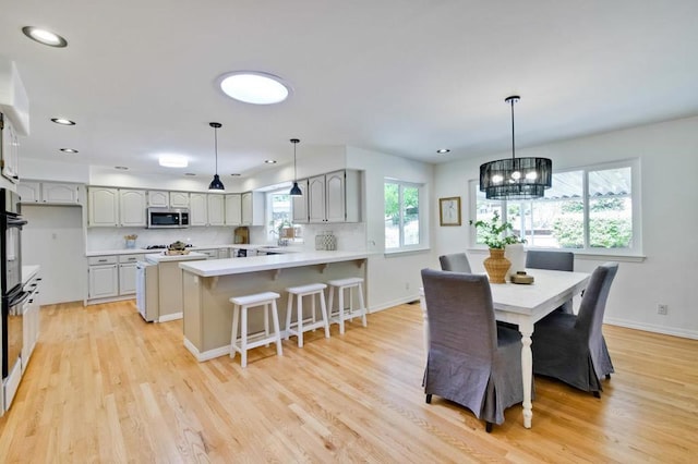 dining room featuring sink and light wood-type flooring