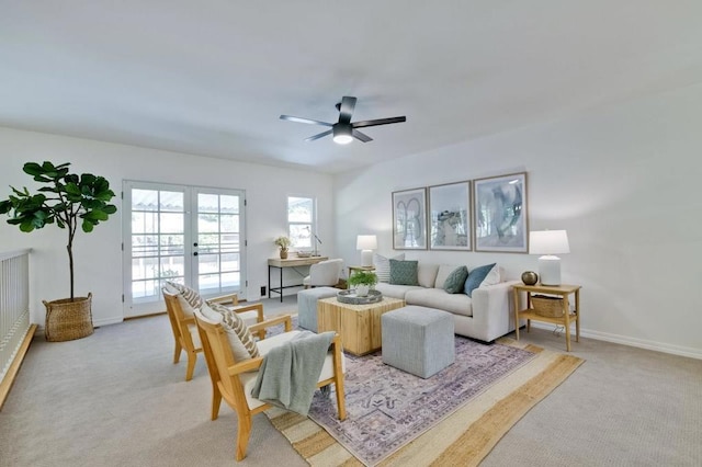 carpeted living room with french doors and ceiling fan