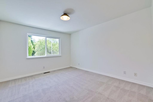 spare room with light colored carpet